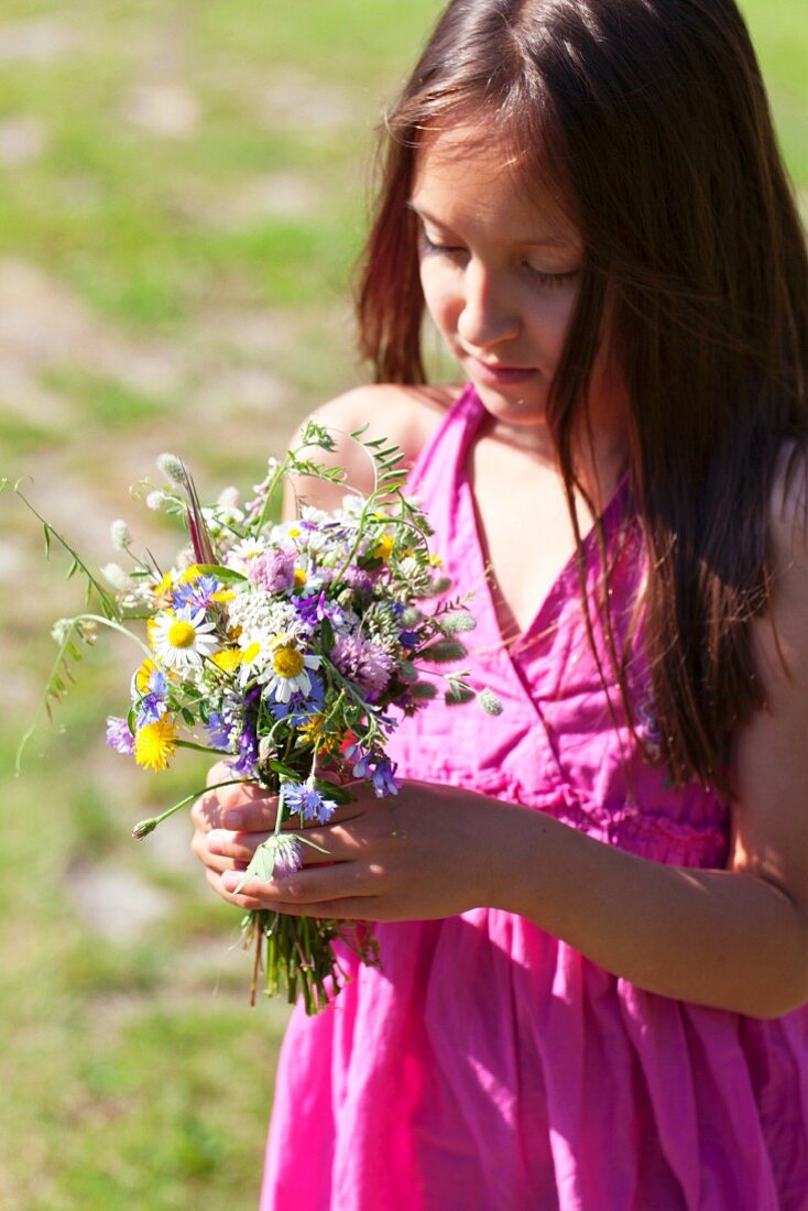 Girl with posy of wild flowers