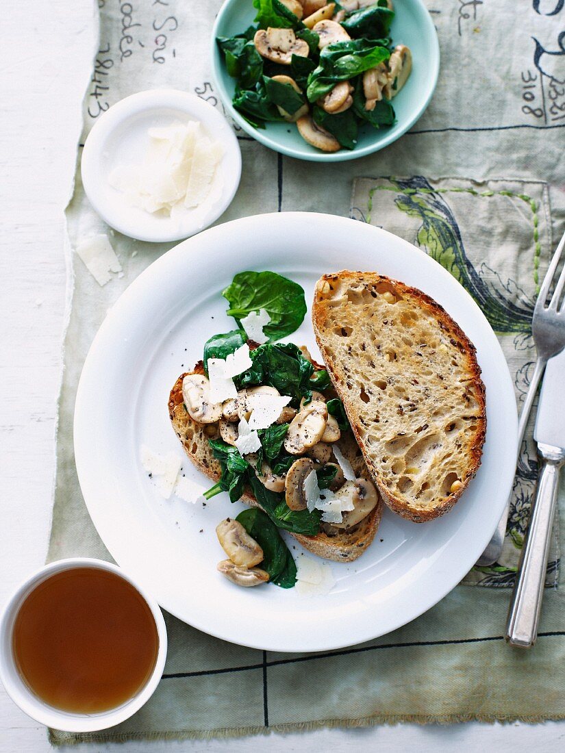 Crostini topped with mushrooms and spinach