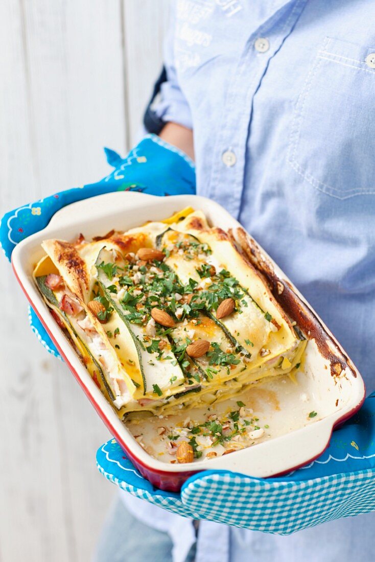 Courgette and ham lasagne with nuts and parsley