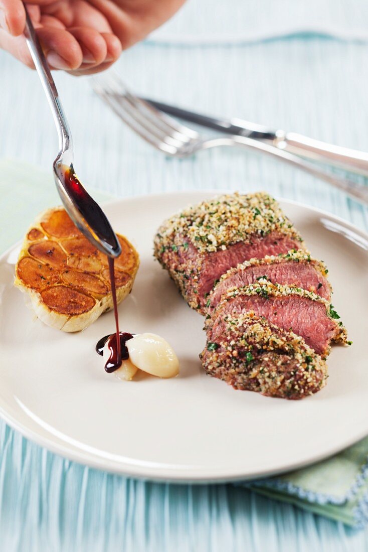 Lamb with a pistachio nut crust with garlic and dark gravy