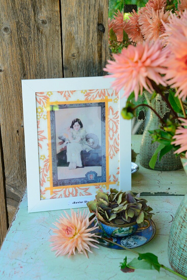 Picture hand-crafted from old postcard, hydrangea in blue china teacup and salmon pink dahlias