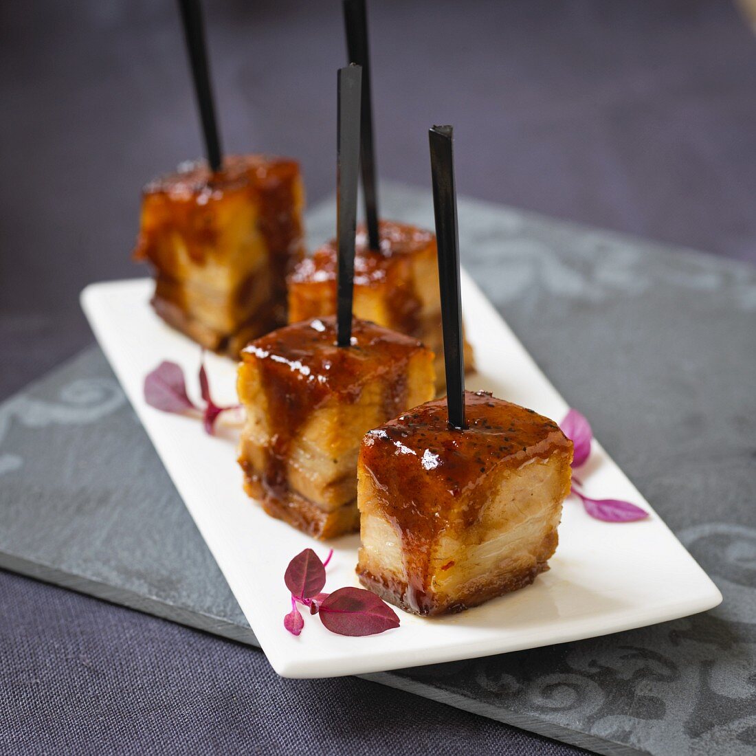 Grilled cubes of pork belly on sticks (Asia)