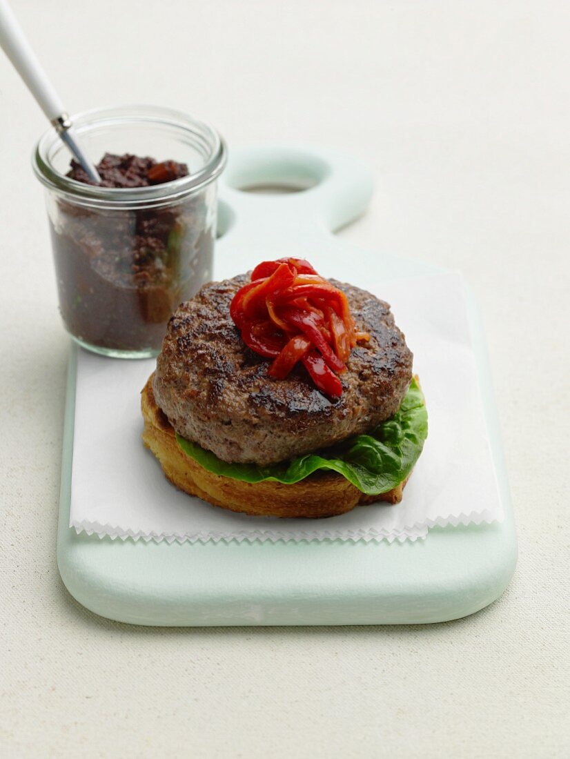 Bread with a lamb burger and red peppers