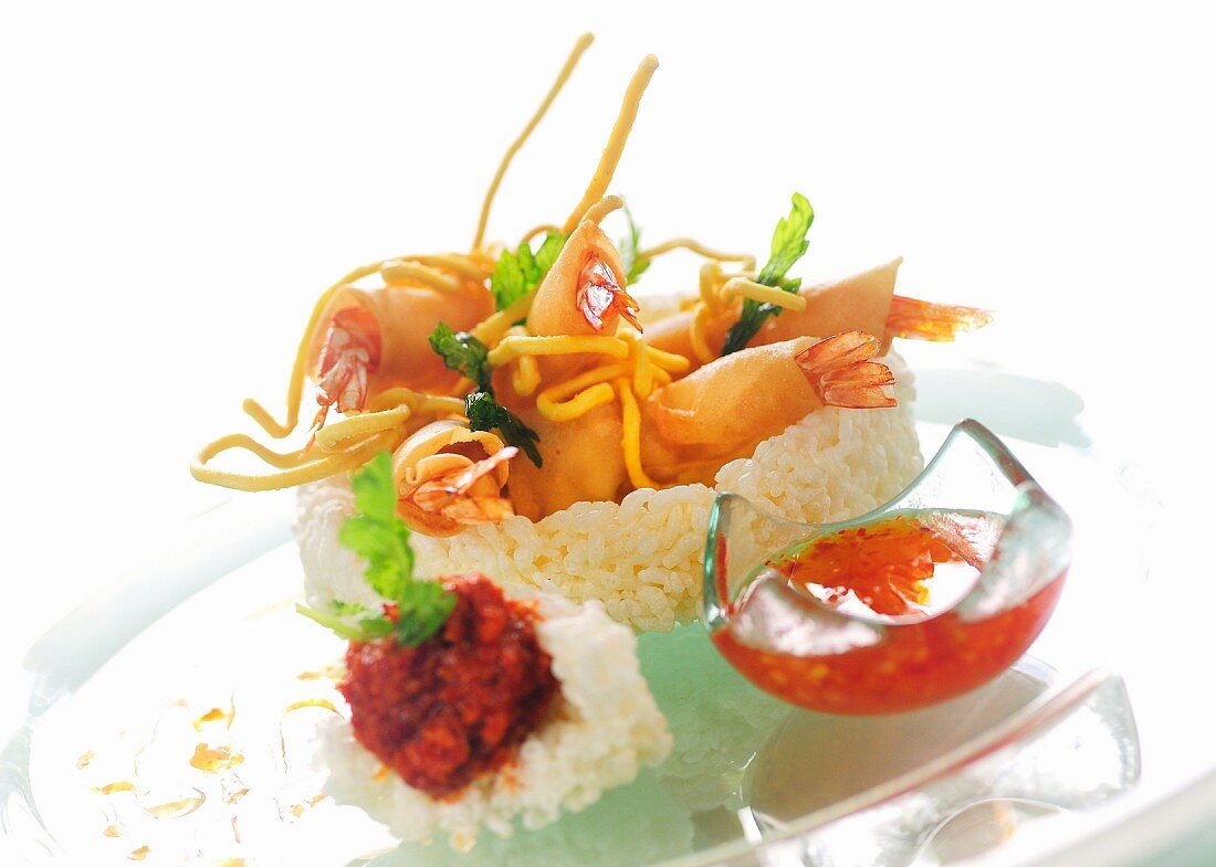Beer-battered prawns with a sweet and sour dip in a rice nest