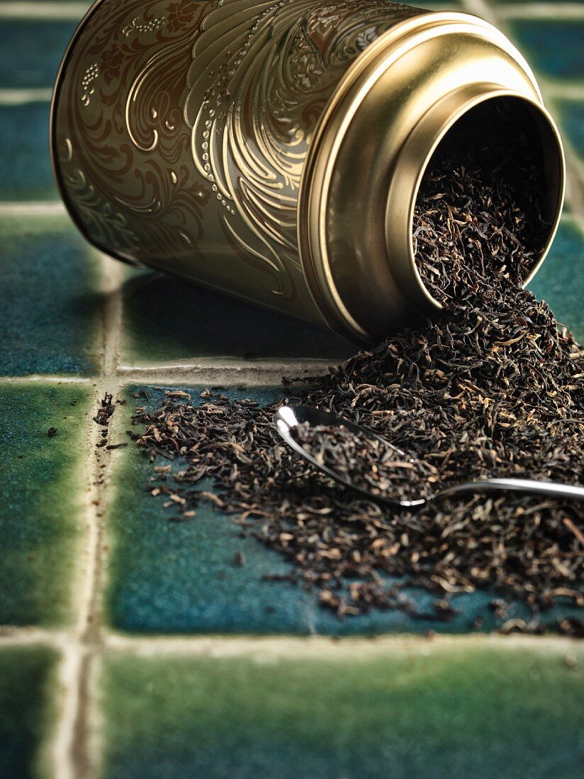 Assam tea leaves in an overturned tin