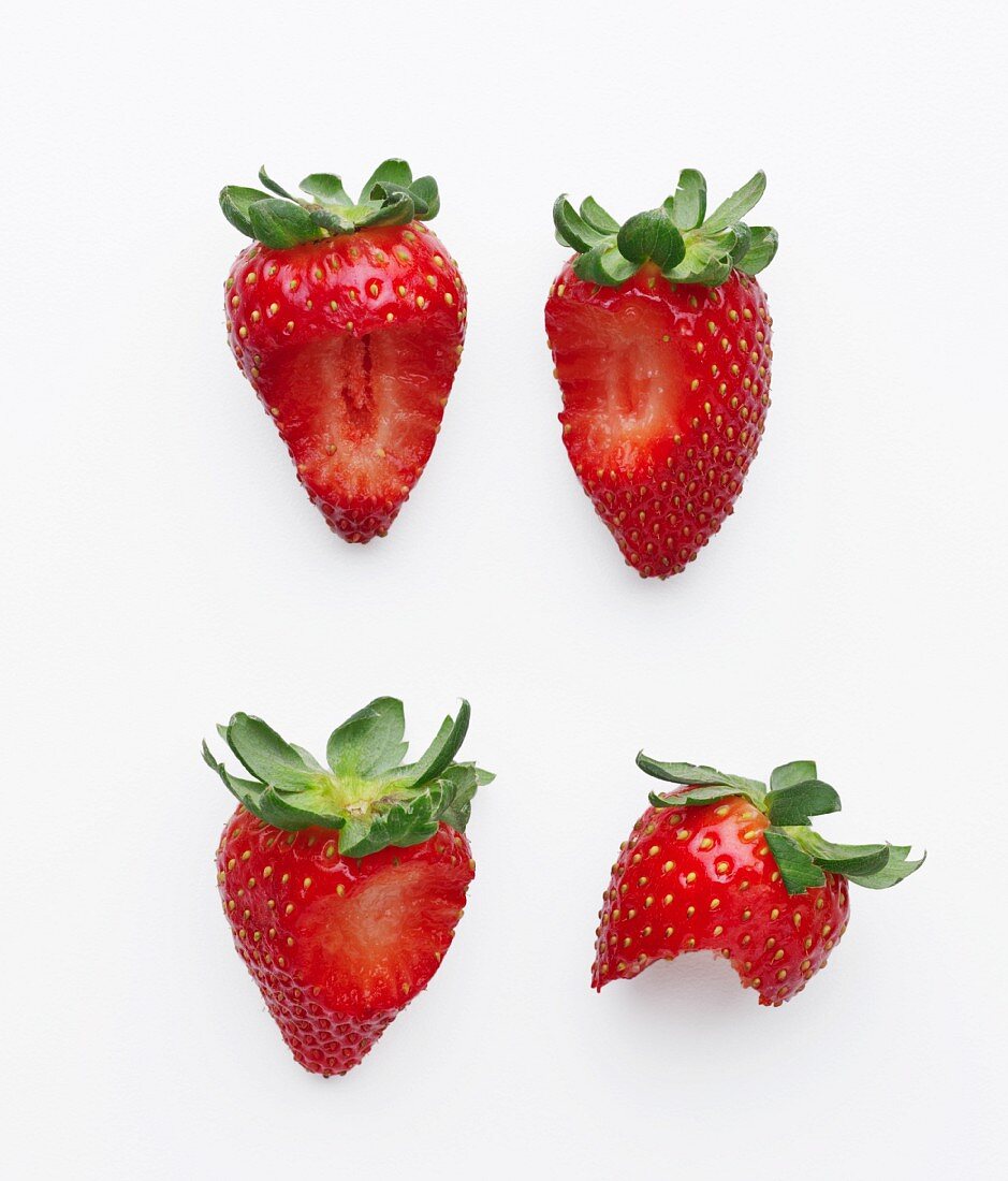 Vier angebissene Erdbeeren