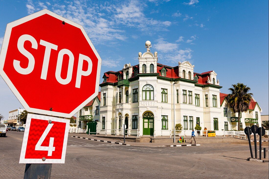 A stop sign in front of the Hohenzollern Haus in Swakopmund, Namibia