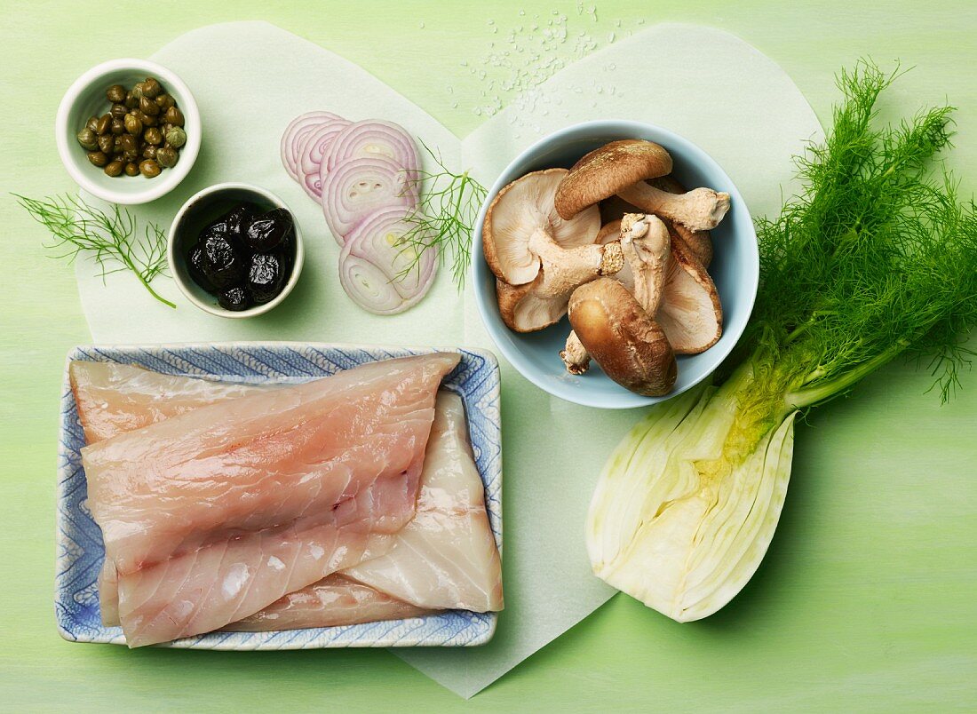 Ingredients for fish en papillote; fennel, striped bass, Shiitake mushrooms