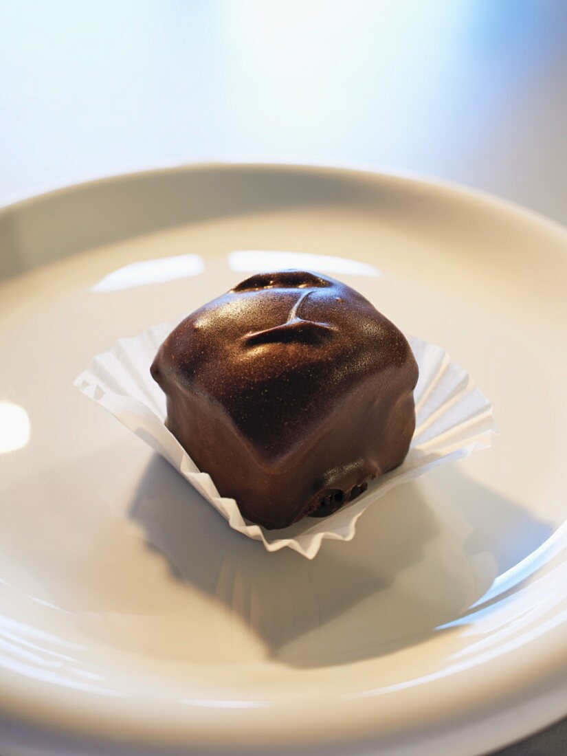 A bite-sized brownie with dark chocolate glaze
