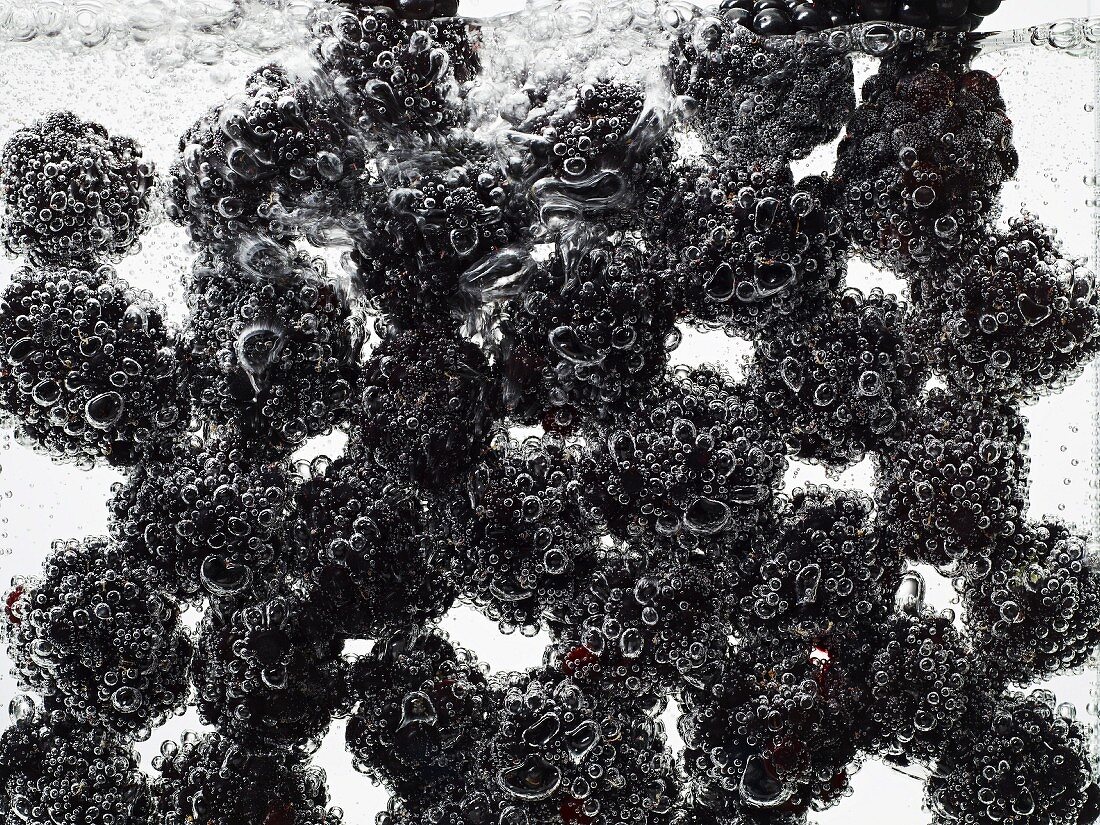 Blackberries under water with bubbles