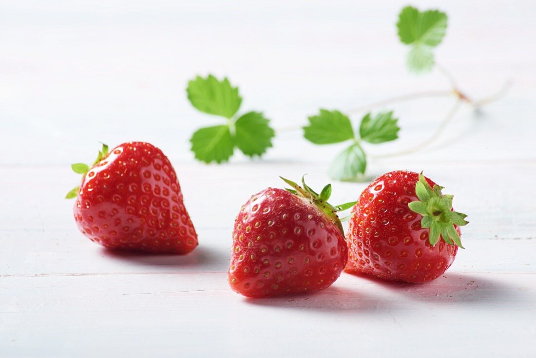 Three strawberries with leaves