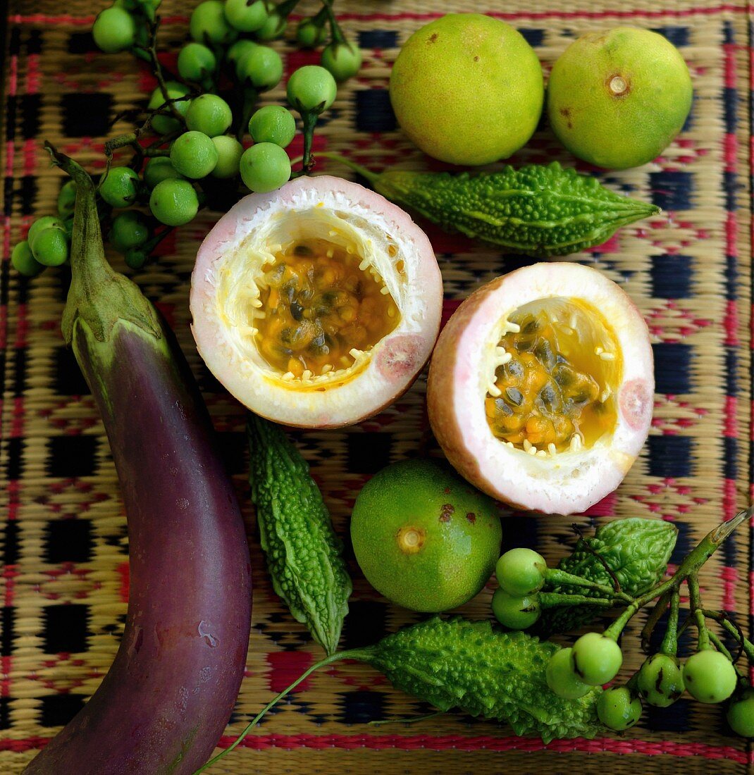 An arrangement of Thai aubergine, bitter gourds, passion fruit and limes