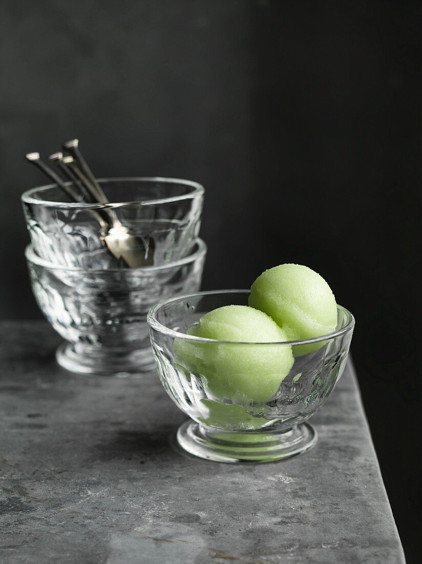 Green apple sorbet in a glass bowl