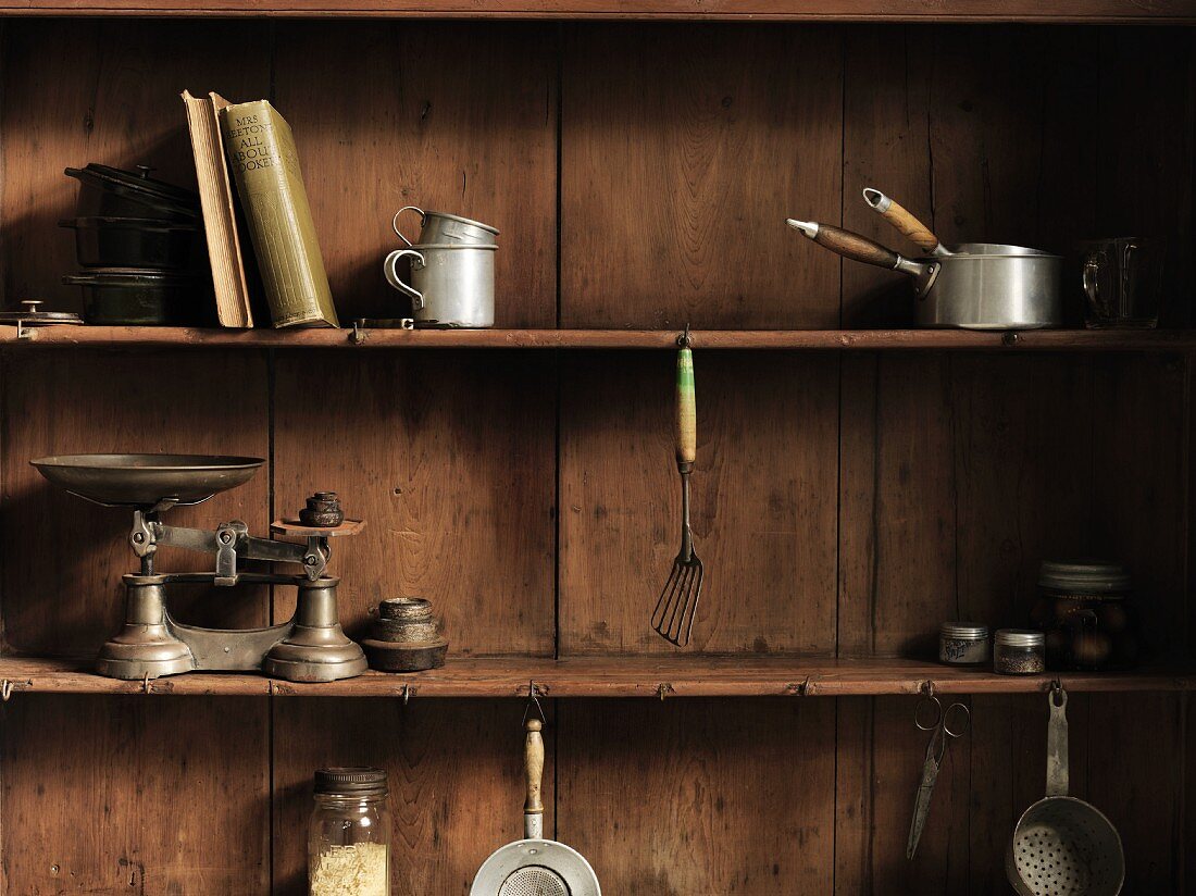 Old kitchen utensils on a wooden shelf