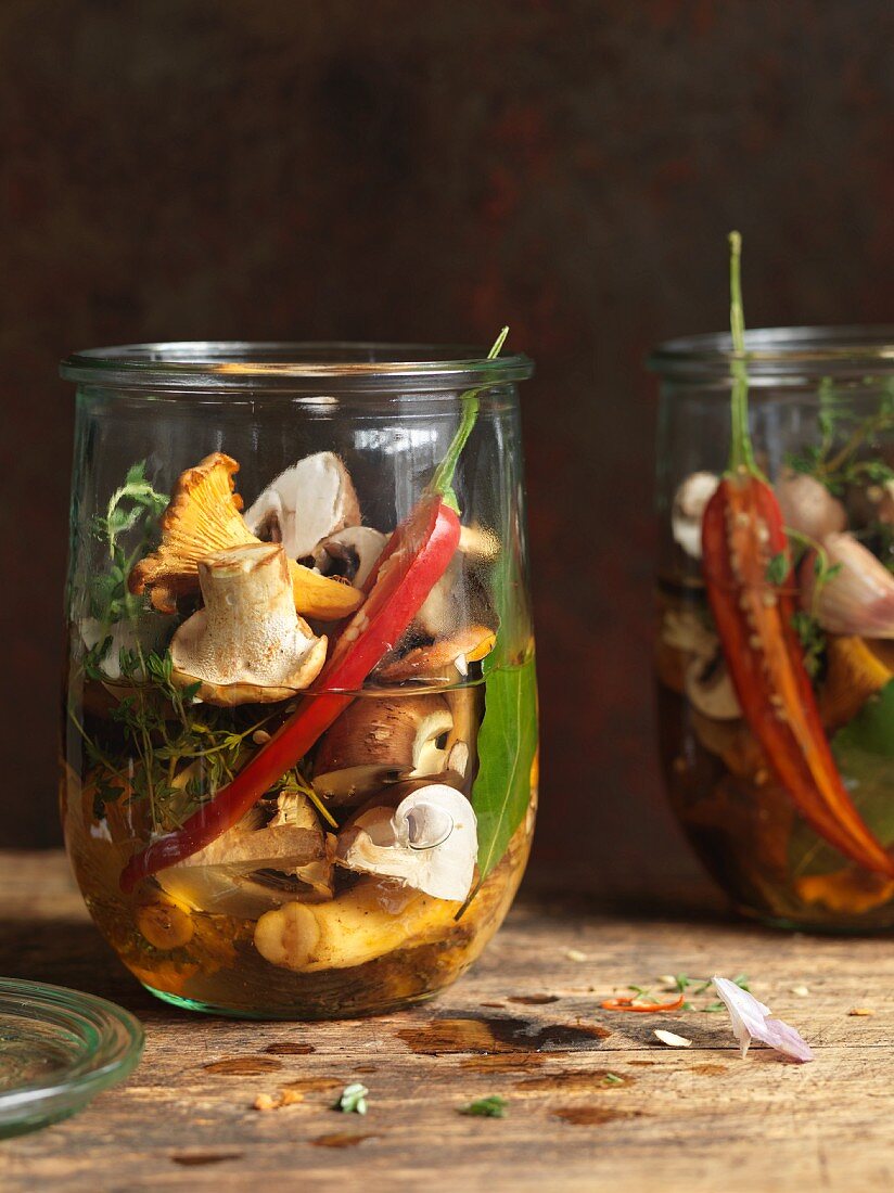 Pickled mushrooms with chilli peppers and herbs