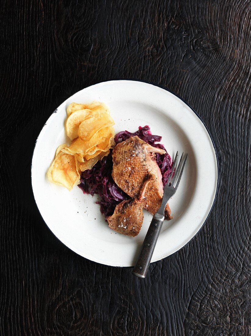 Roast wild duck with braised red cabbage and potato crisps
