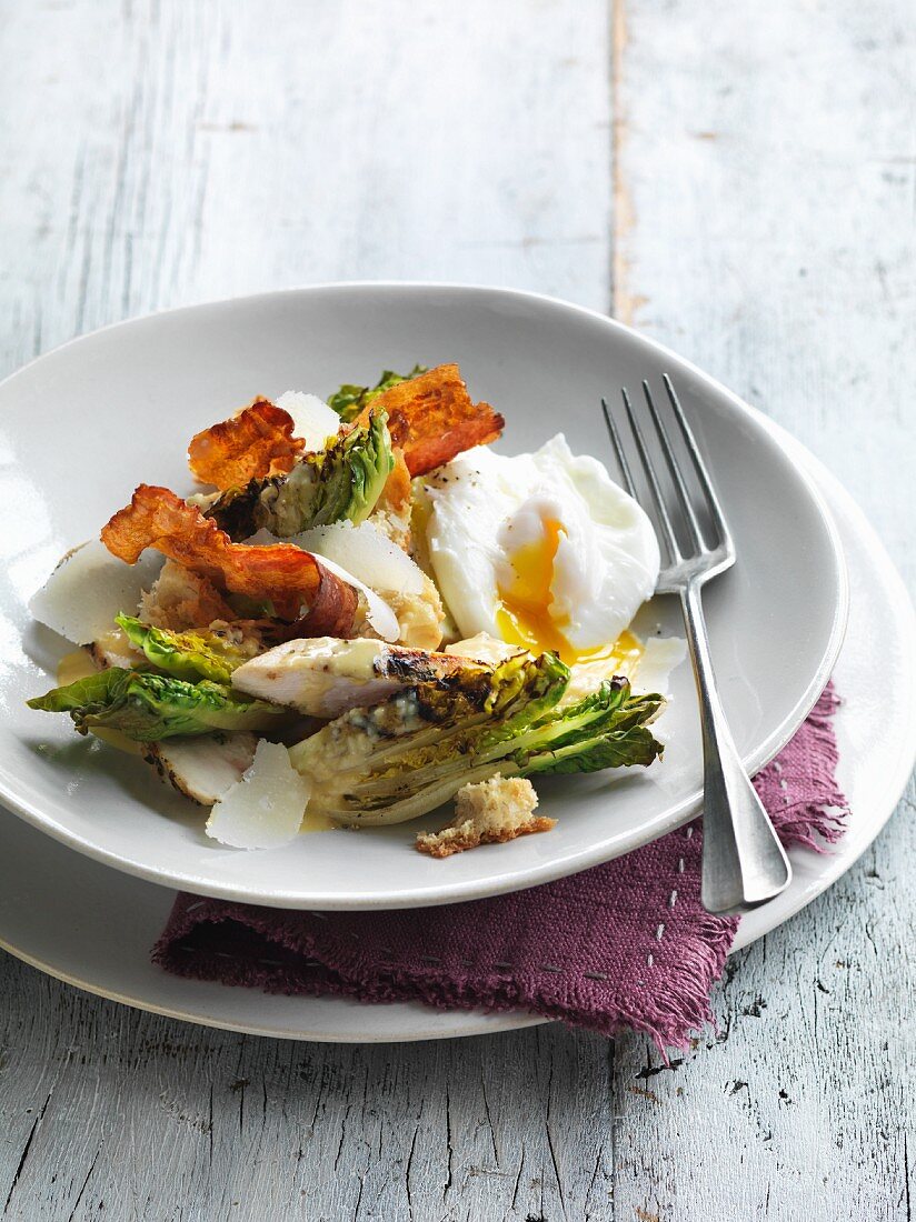 Caesar salad with chicken, bacon and poached egg