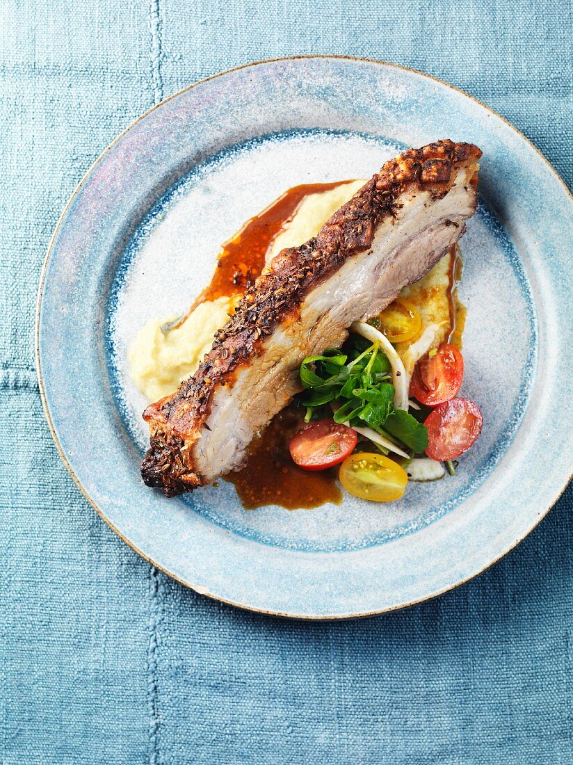 Spicy roast pork belly with fennel puree and a fennel and tomato salad