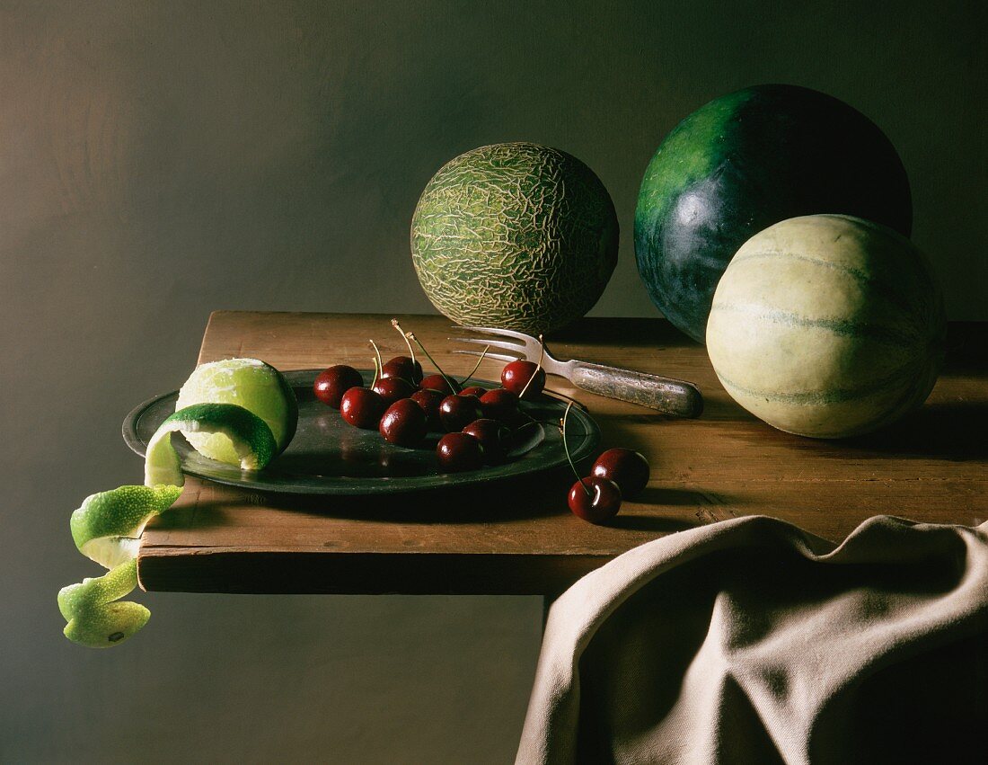 An arrangement of melons, cherries and limes