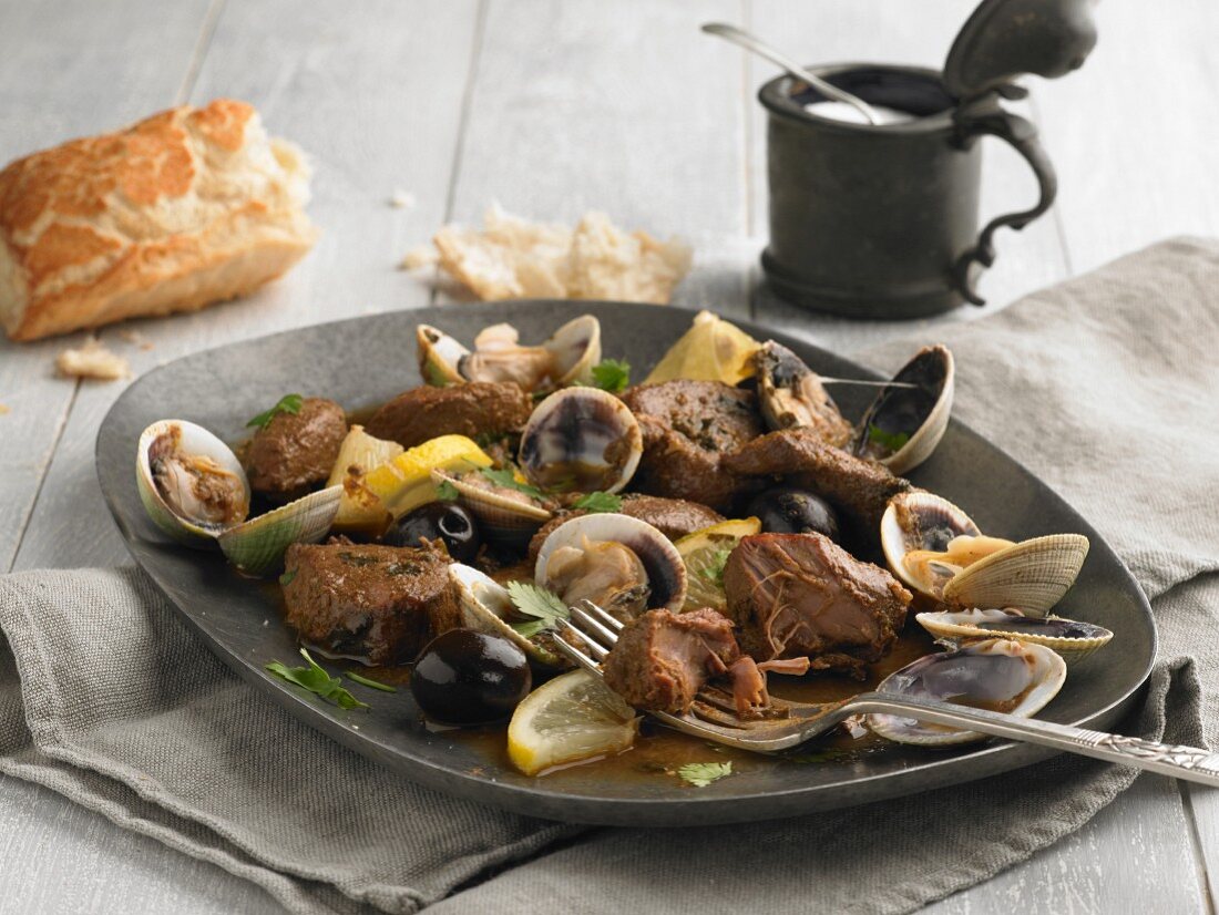 Pork with mussels, olives, lemons and coriander