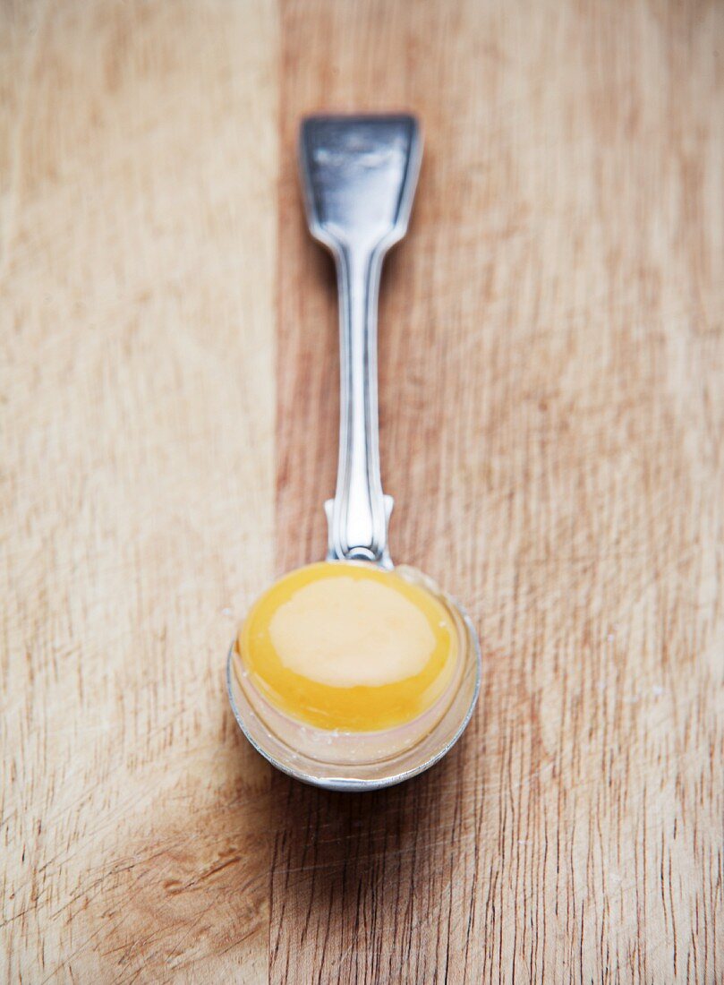 An egg yolk on a spoon