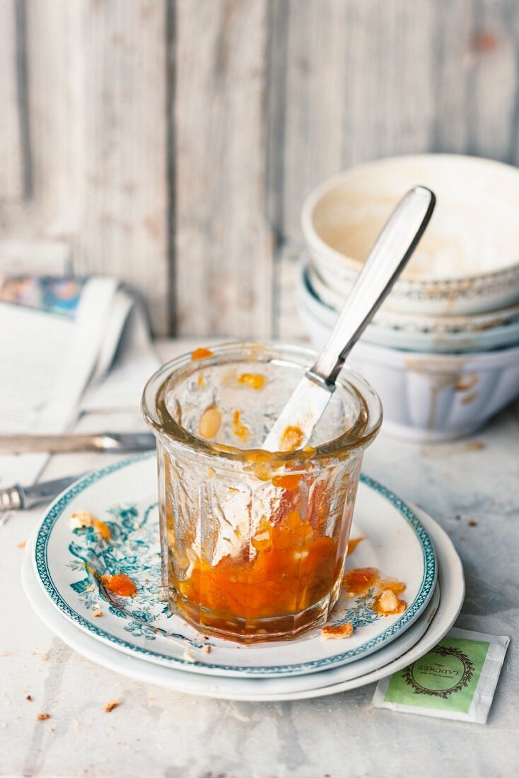A half-eaten jar of apricot jam