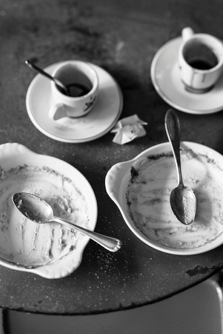 Empty dessert bowls and espresso cups