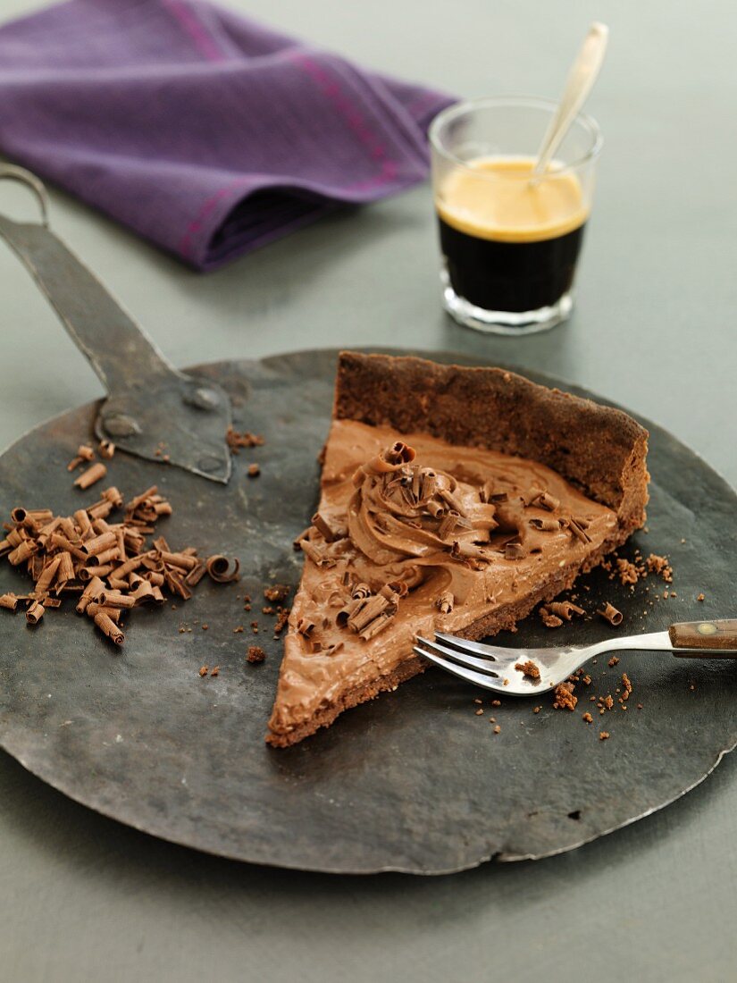A slice of chocolate mousse cake with coffee