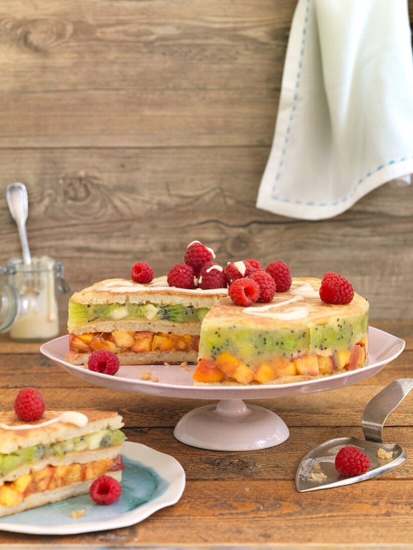 A pancake cake with kiwis, nectarines and raspberries
