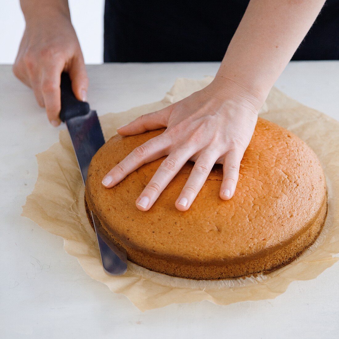 A cake being cut into two halves