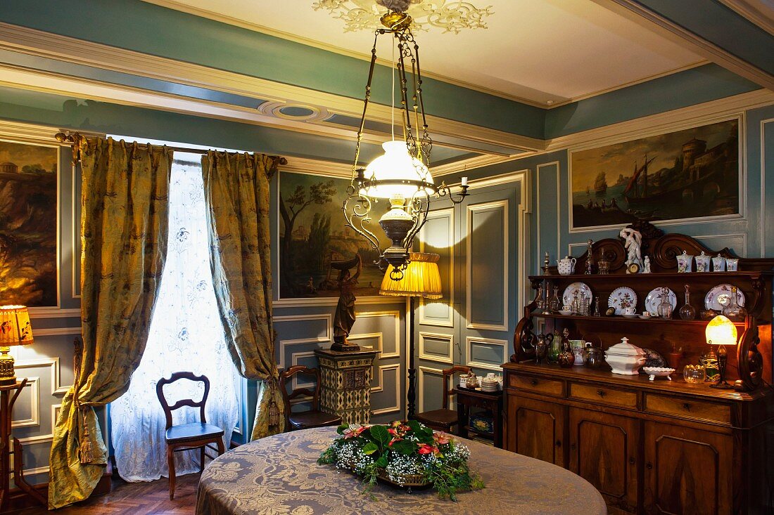 Historic house in Burgundy - dining room with blue and white wood panelling and elegant furnishings