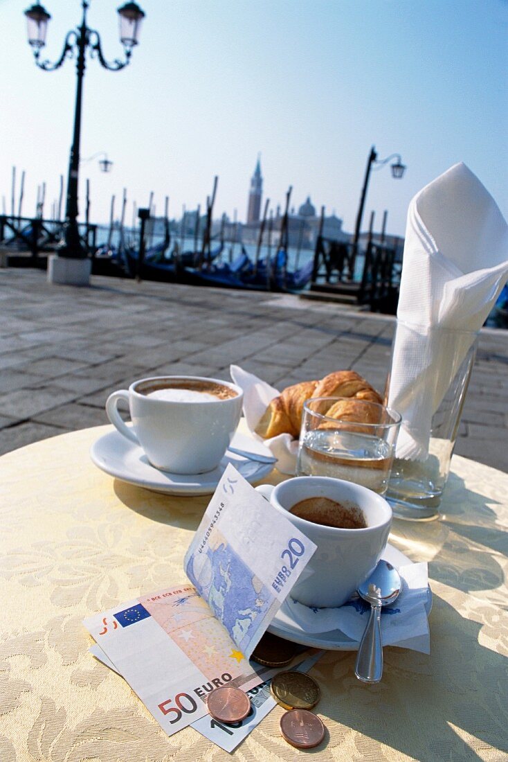 Coffee, pastries and money at a pavement cafe in Venice, Italy