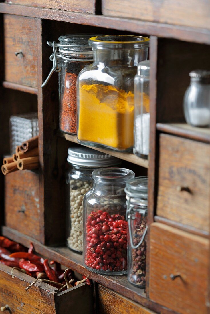 Spices on an antique wooden kitchen shelf