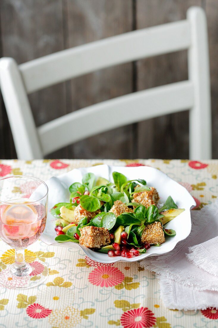 Lamb's lettuce with pomegranate seed and sesame seed feta cubes