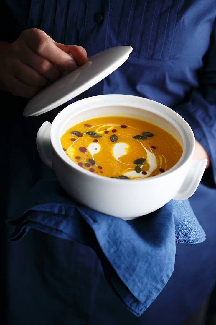 Cream of pumpkin soup with pumpkin oil and pumpkin seeds