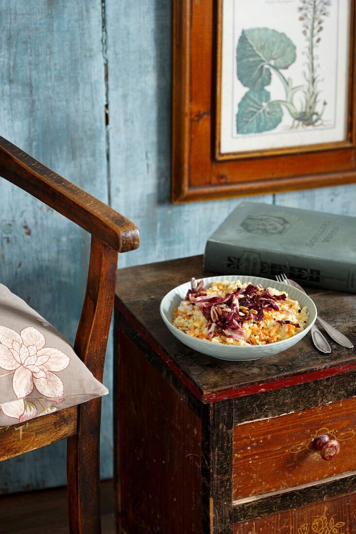 Carrot risotto with radicchio on an old wooden sideboard