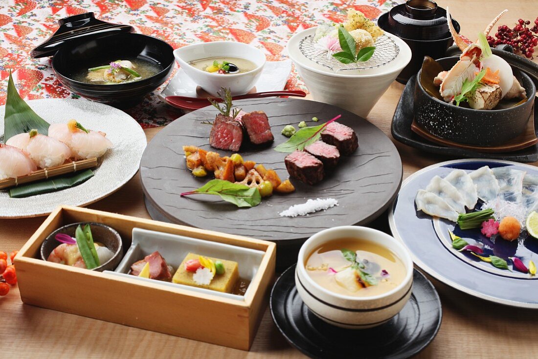 Traditionelle Gerichte aus Japan: Sushi, Rindfleisch, Tempura und Muscheln