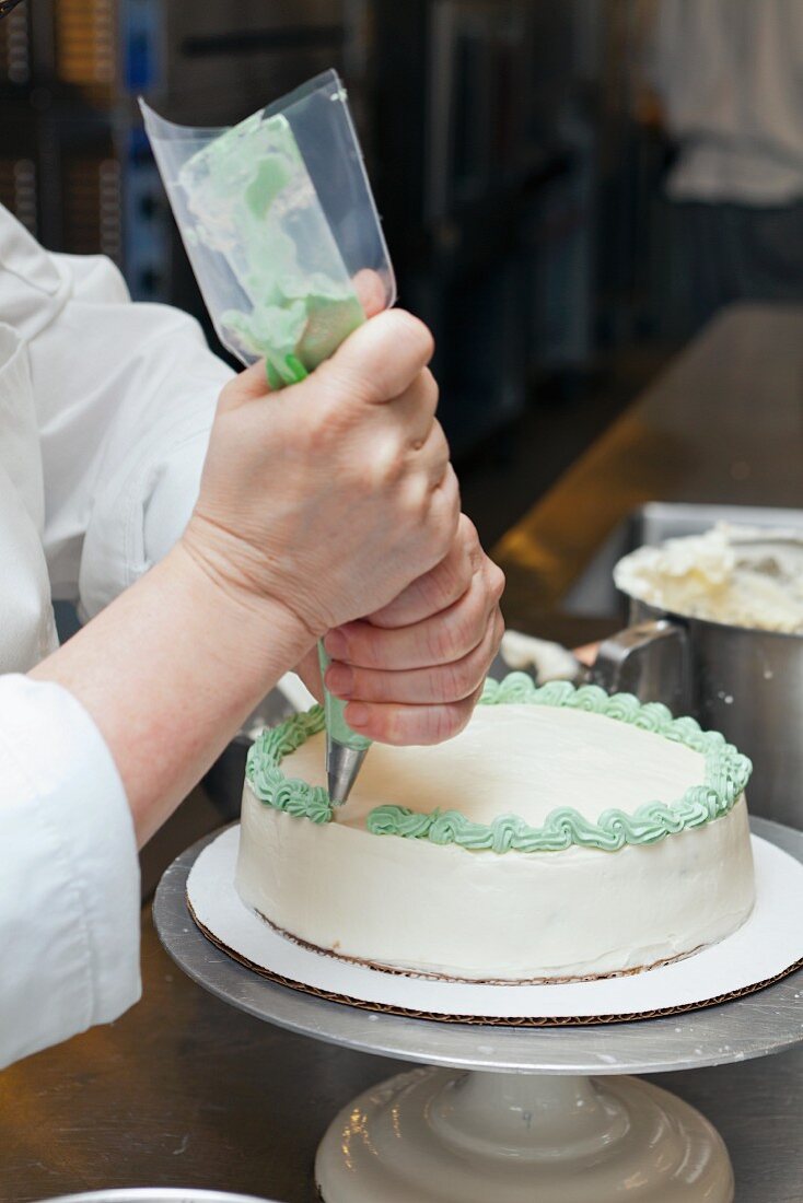A chef icing a cake