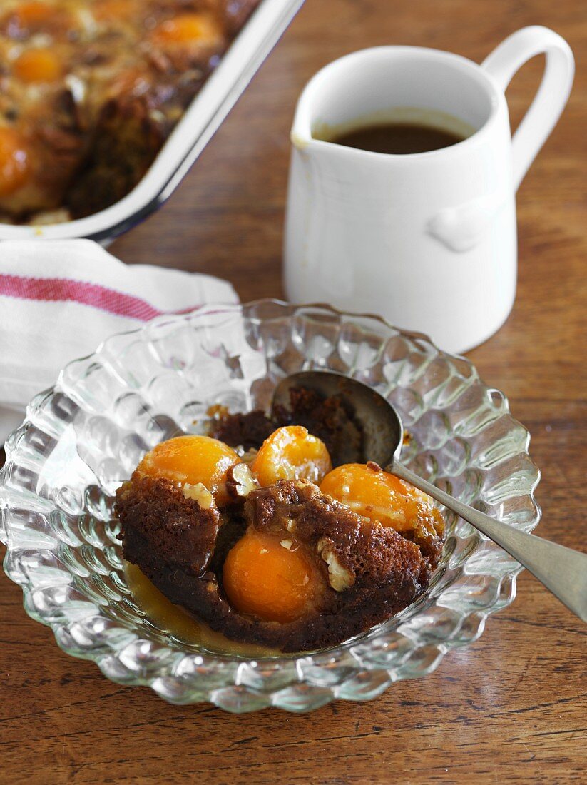 A portion of Sticky Date Pudding with apricots and peaches