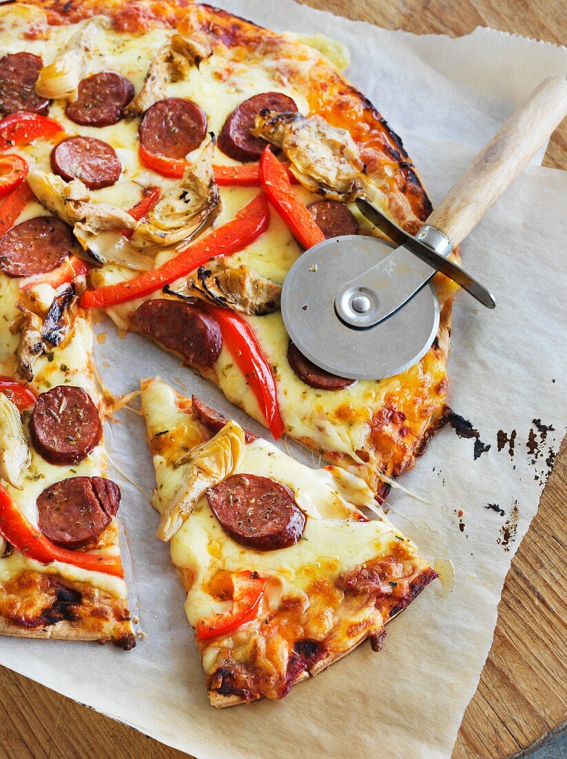 Artichoke pizza with sausage, cheese and peppers