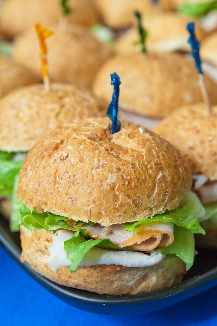 Turkey sandwiches with iceberg lettuce on a tray (close-up)