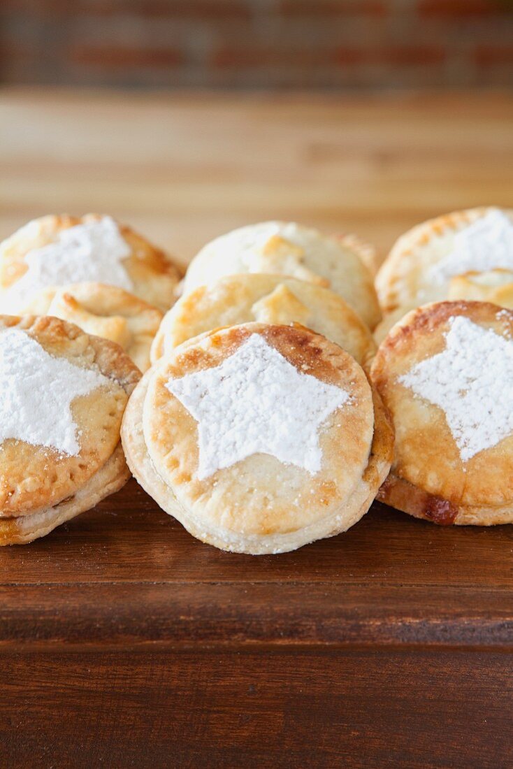 A row of mince pies on a wooden table