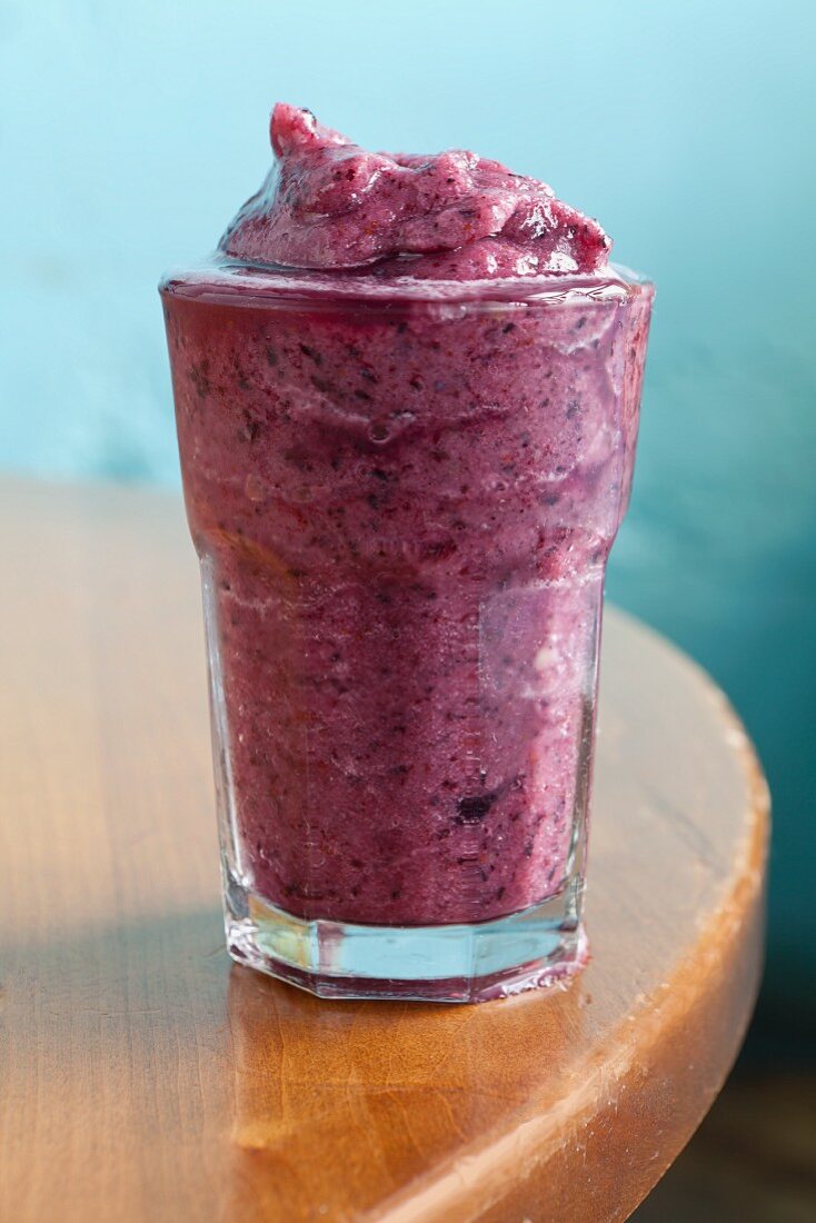 A blueberry and banana smoothie with apple juice