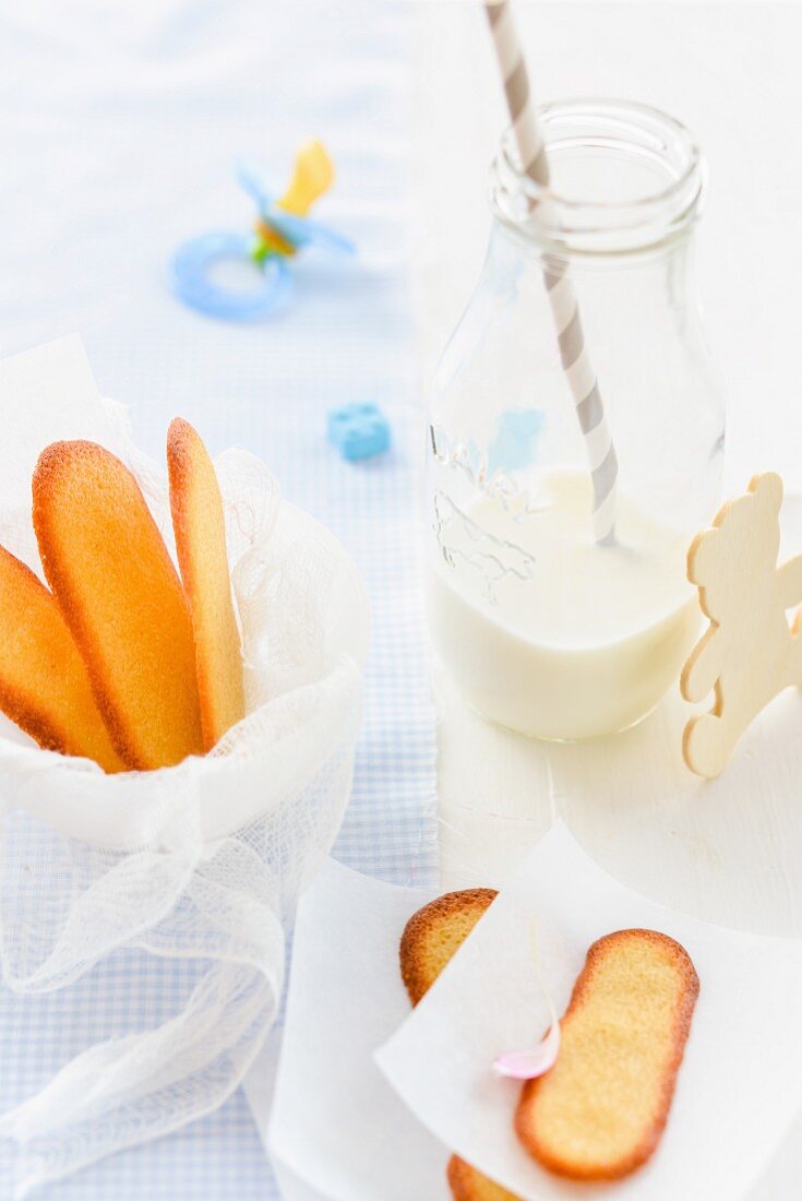 Sponges fingers and a bottle of milk as baby food