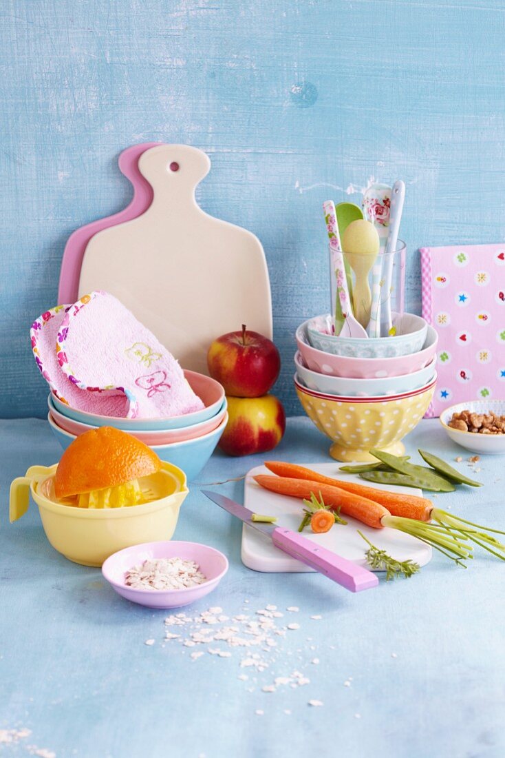 An arrangement of children's tableware, fruit and vegetables