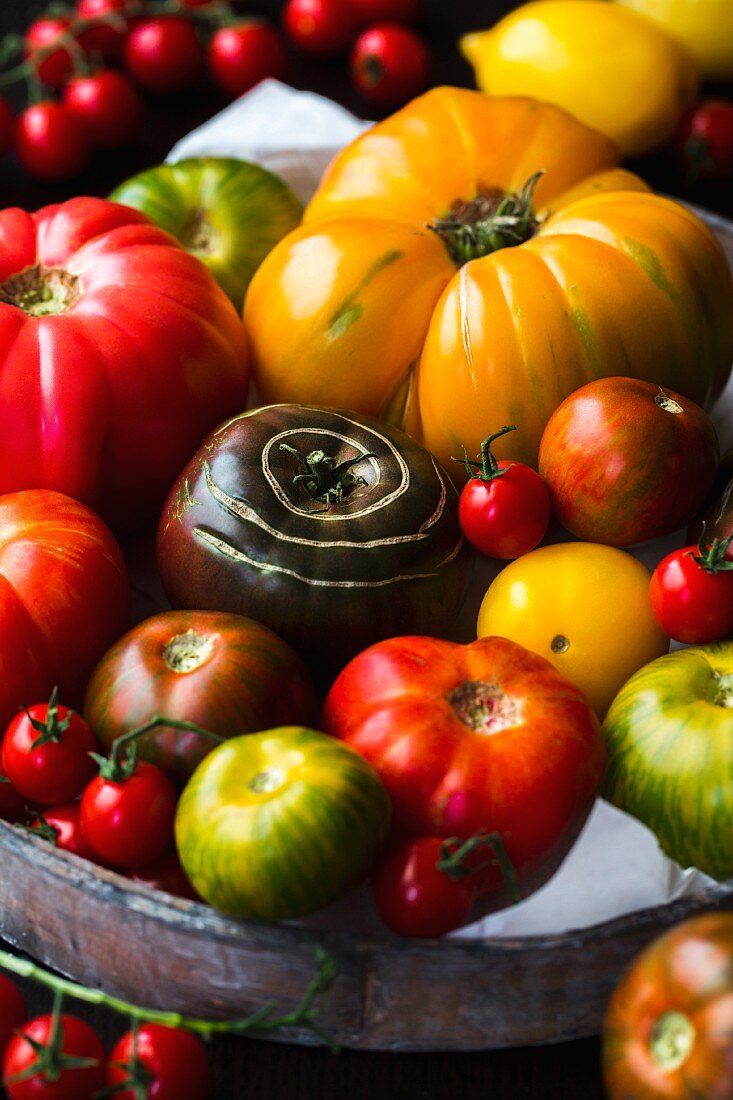Various heirloom tomatoes on a wooden tray