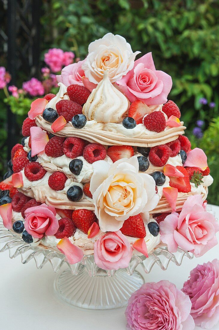 A meringue cake with berries and flowers