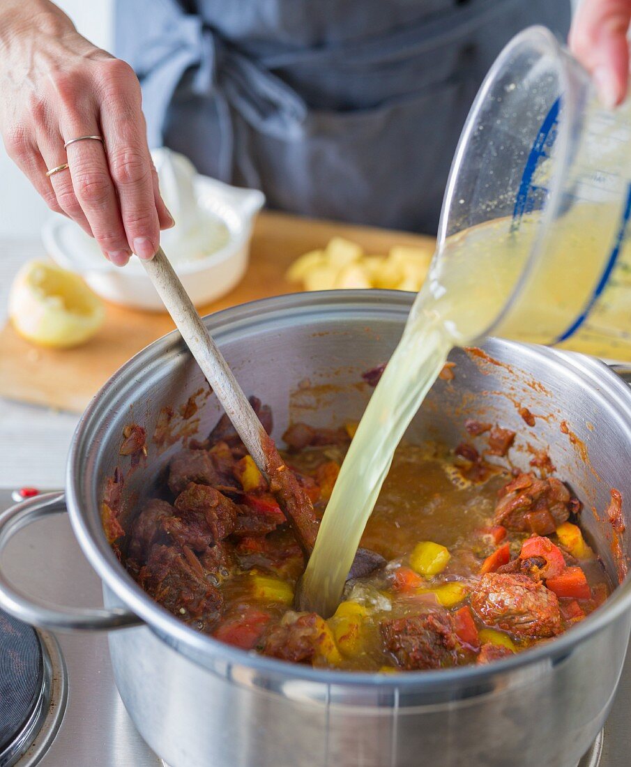 Goulash soup being made: stock being added to goulash