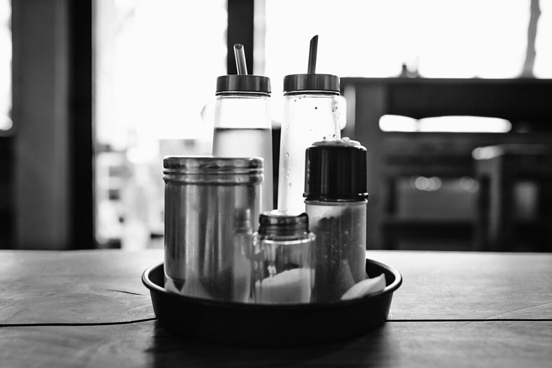 A cruet (salt, pepper, oil and vinegar) in a restaurant