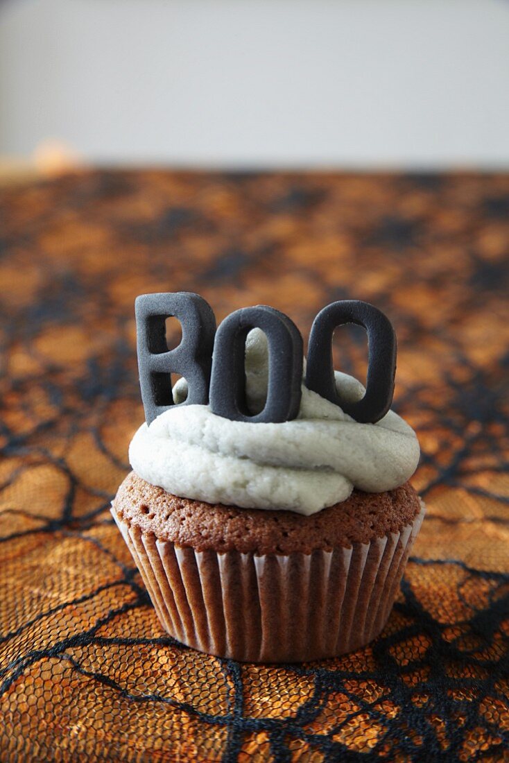 Halloween cupcakes topped with buttercream icing and decorative letters